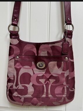 Coach F17479 Penelope Optic Signature Hippie Bag in burgundy/plum 11”x10.5”x0.5”